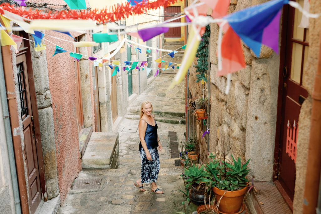 Wandering a colorful alley in Ribeira, Porto, with bunting overhead