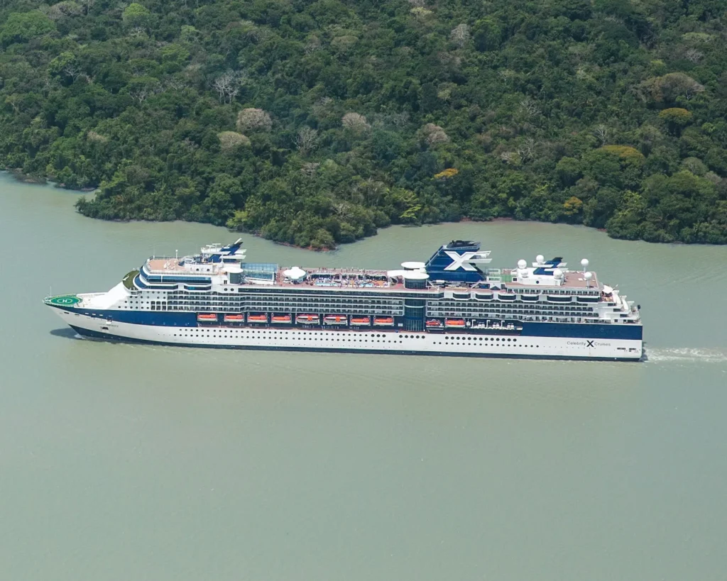 Cruise ship sailing through lush tropical coastline near Costa Rica