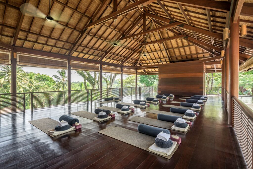 Yoga Mats in Jungle yoga pavilion with bolsters and other yoga props.
Corporate retreat trends 2026 — luxury group travel offsite planning
