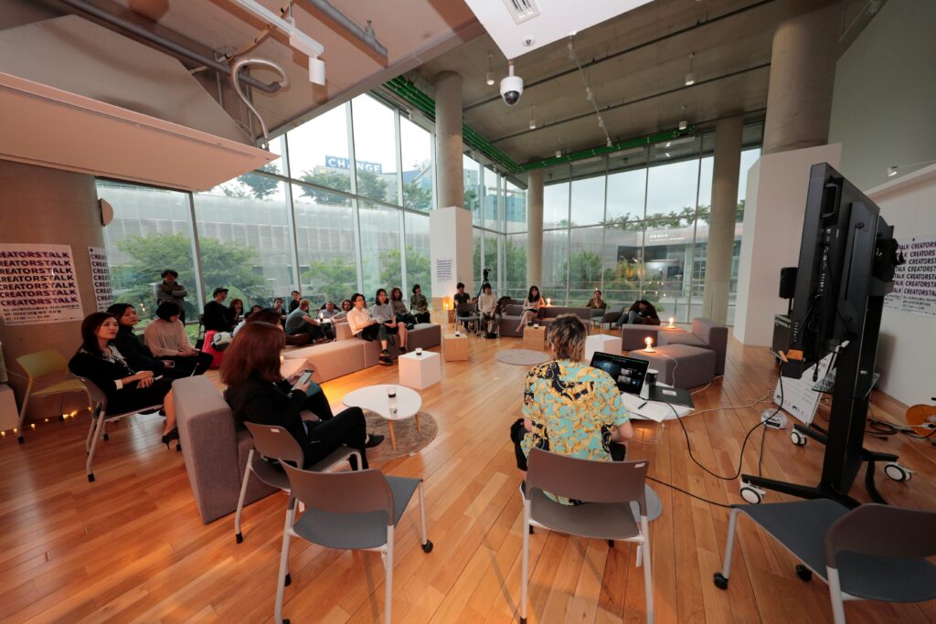 Company meeting with people on couches and small desks. Corporate retreat trends 2026 — luxury group travel offsite planning