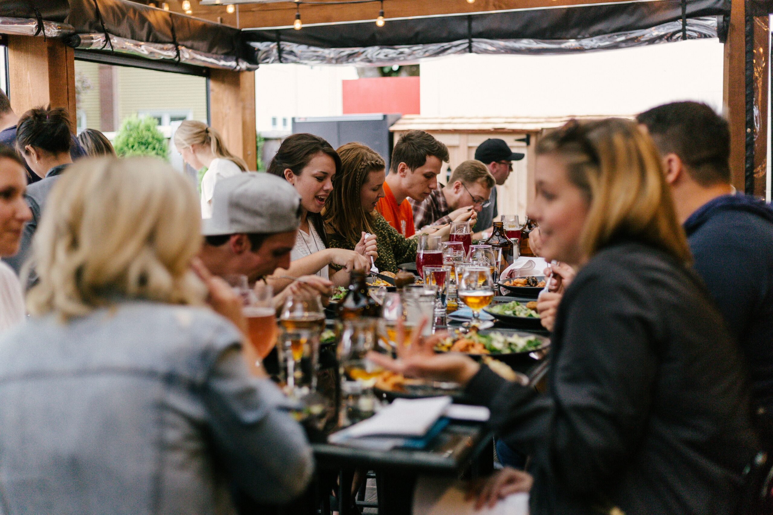 Group of happy people at a dinner. Corporate retreat trends 2026 — luxury group travel offsite planning.