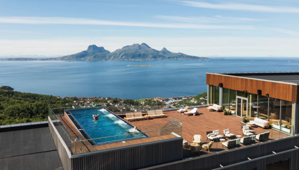 Rooftop pool and terrace at Wood Hotel Bodø overlooking the sea and mountains in Norway
